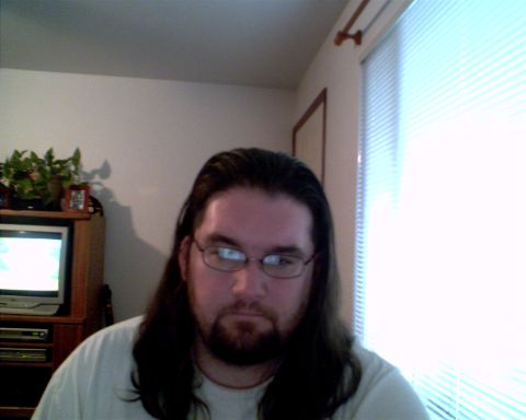 1993 Ford Bronco - A man with long hair and glasses is visible in this indoor photograph.