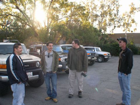 2007 Toyota FJ Cruiser - Several Toyota FJ Cruisers are parked in a lot with a group of men.