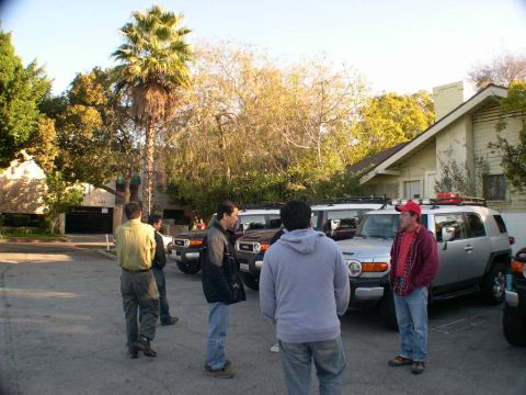 2007 Toyota FJ Cruiser - Several Toyota FJ Cruisers are gathered in a parking lot, with a group of people standing nearby.