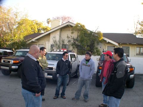 2007 Toyota FJ Cruiser - Several men stand in a parking lot with two Toyota FJ Cruisers visible.