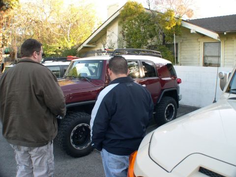 2007 Toyota FJ Cruiser - Maroon 2007 Toyota FJ Cruiser with two men nearby. Another vehicle is parked to the right.