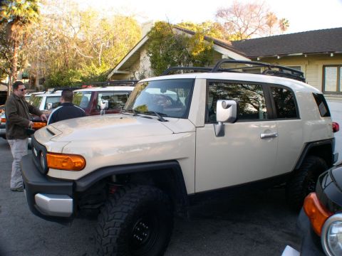 2007 Toyota FJ Cruiser - Several Toyota FJ Cruisers are parked in a driveway on a sunny day.
