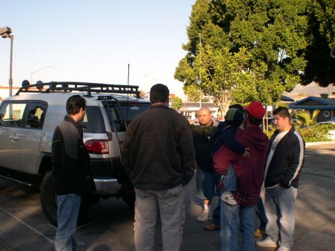 2007 Toyota FJ Cruiser - A group of people stand around a silver 2007 Toyota FJ Cruiser in a parking lot.
