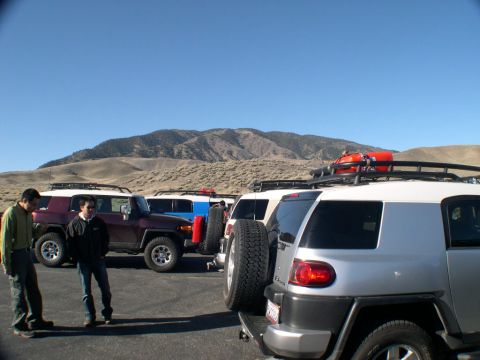 2007 Toyota FJ Cruiser - Several Toyota FJ Cruisers are parked in a lot with mountains in the background.