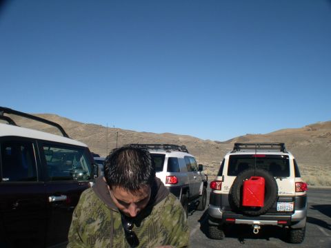 2007 Toyota FJ Cruiser - Two FJ Cruisers are parked in a desert landscape under a clear blue sky.