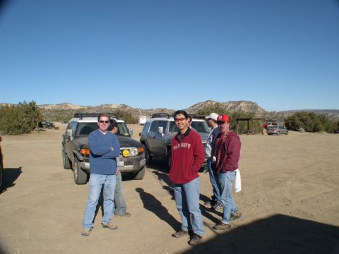 2007 Toyota FJ Cruiser - A group of people stand around a Toyota FJ Cruiser in a desert landscape.