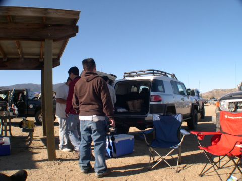 2007 Toyota FJ Cruiser - A group of people gather around a silver 2007 Toyota FJ Cruiser with its rear hatch open.