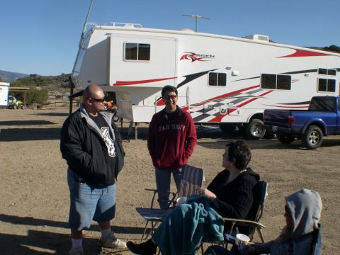 2007 Toyota FJ Cruiser - People gather outdoors near a large RV and a blue pickup truck on a sunny day.