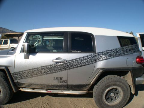 2007 Toyota FJ Cruiser - Silver 2007 Toyota FJ Cruiser with distinctive tire track graphics and a sticker for the LA Auto Show is seen from the side.