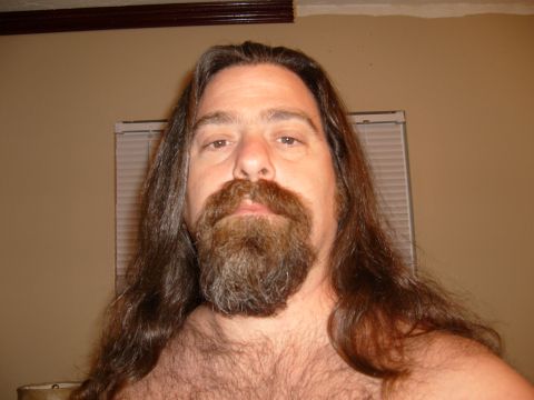 1995 Ford Bronco - A man with long hair and a full beard is shown from the chest up.