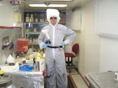 1979 Chevrolet Blazer - Person in protective gear with spray gun in a workshop environment.