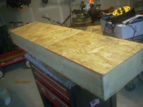 1992 Ford Bronco - A wooden storage box sits atop a red toolbox in a workshop setting.