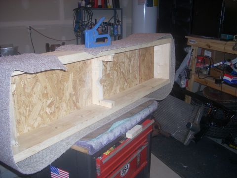 1992 Ford Bronco - Construction of a custom storage box using plywood and carpet, with a stapler visible.