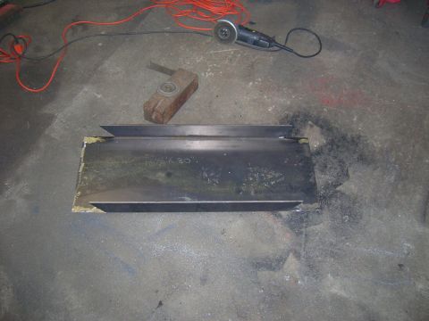1979 Ford Bronco - Metal bracket and tools on a garage floor.