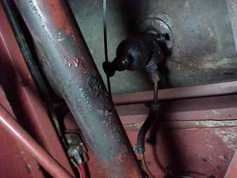 1912 Ford Model T - Close-up view of a vehicle's undercarriage, showing mechanical components and wiring.