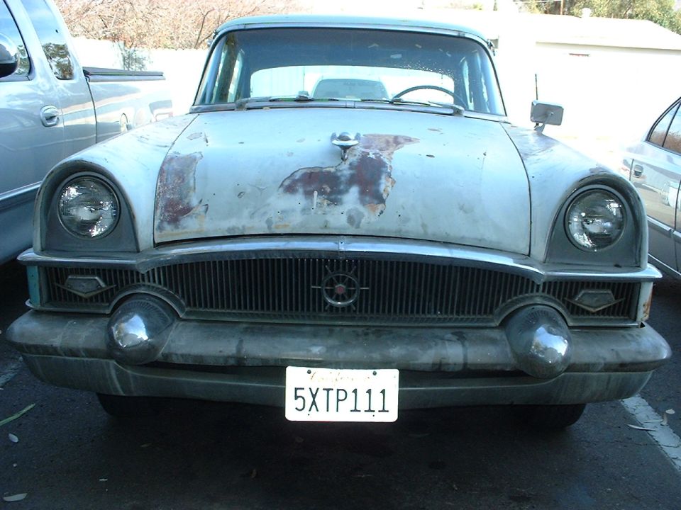 Light-colored truck rear with a license plate and a decal on the back window