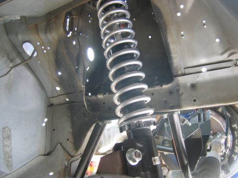 1992 Ford Mustang - Close-up of a front suspension coilover shock absorber, likely a performance upgrade part.