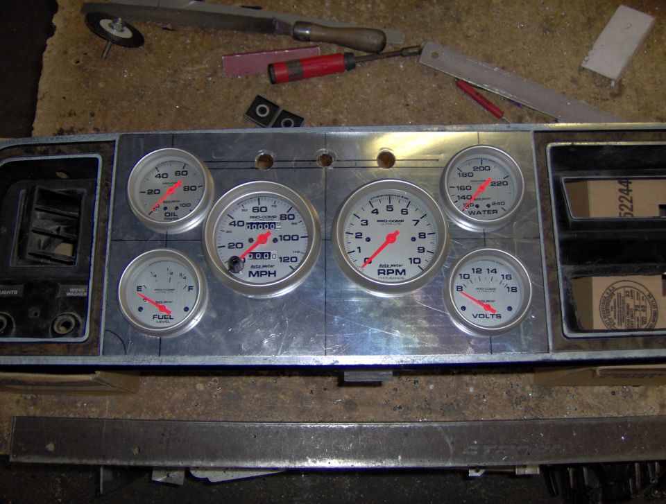Custom aluminum dash panel fitted with white-face Auto Meter gauges