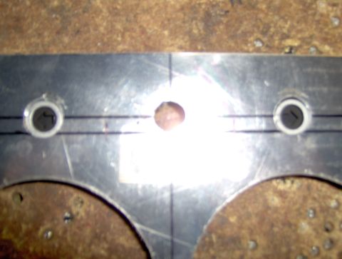 1978 Ford Bronco - Close-up of a metal part with drilled holes and layout lines.