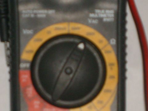 1993 Ford Bronco - Multimeter dial shows settings for voltage and resistance measurements.