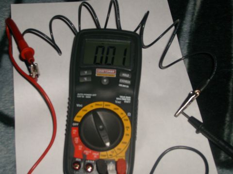 1993 Ford Bronco - A Craftsman multimeter is shown with its leads connected, displaying a reading of 0.01.