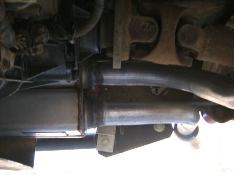 1991 Ford Bronco - Underside view of exhaust system and driveshaft components.