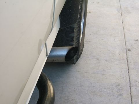 1991 Ford Bronco - Close-up view of a vehicle's exhaust pipe and tire.
