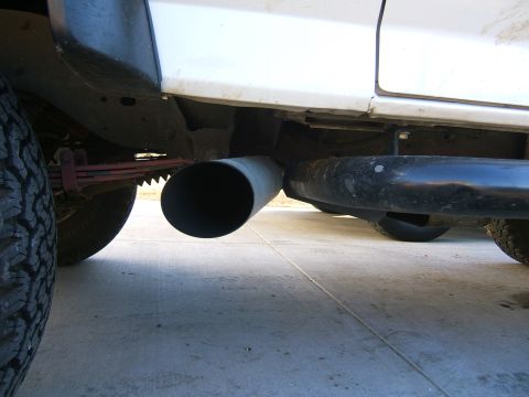1991 Ford Bronco - Vehicle's exhaust pipe and leaf spring are visible from a low angle.