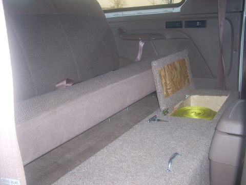 1992 Ford Bronco - The interior of a 1992 Ford Bronco shows a custom storage compartment behind the rear seat.