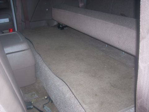 1992 Ford Bronco - Interior view of the rear cargo area in a 1992 Ford Bronco, showing the floor and folded seat.