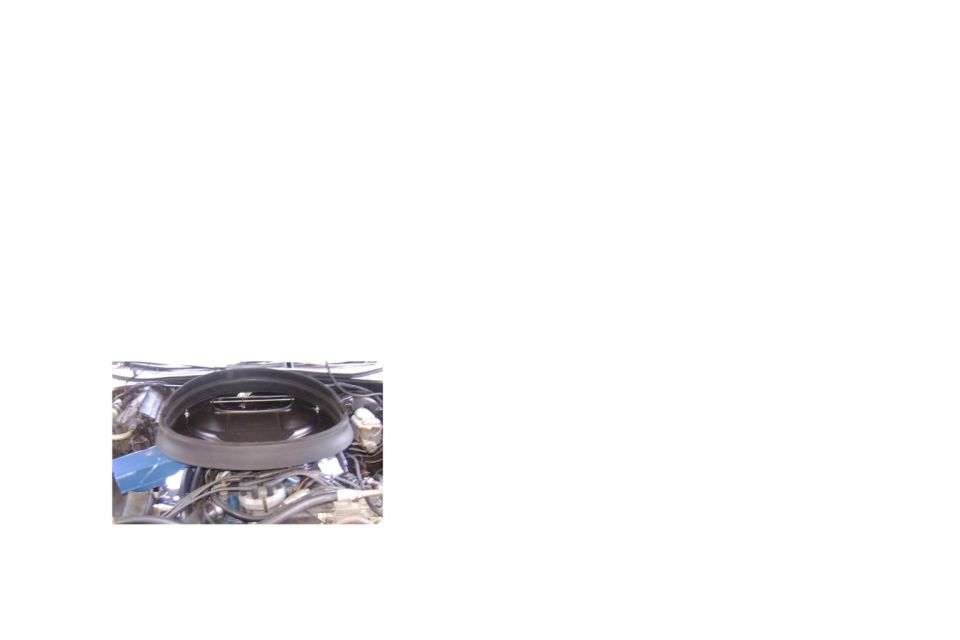 Black air cleaner assembly atop an engine, small cropped photo
