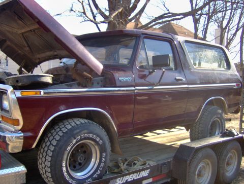 1996 Ford Bronco - A maroon Ford Bronco is shown on a trailer with its hood open, revealing the engine bay.