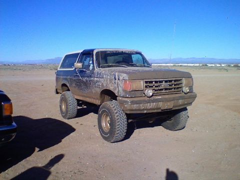 1991 Ford Bronco - This lifted Ford Bronco is covered in mud after an off-road excursion.