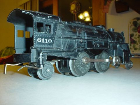 2000 Ford Crown Victoria - A black toy train engine, marked with the number 6110, is displayed on a flat surface.