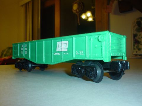 2000 Ford Crown Victoria - A green Lionel train car with PC 80 33 markings is shown from the side.