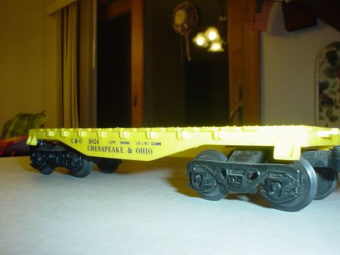 2000 Ford Crown Victoria - A close-up side view of a yellow toy train car with Chesapeake & Ohio markings.