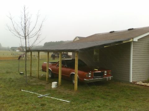 1979 Ford Ranchero - Red 1979 Ford Ranchero sits under a makeshift carport on a cloudy day.