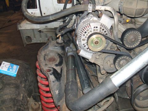 1995 Ford Bronco - Close-up view of the engine bay of a 1995 Ford Bronco, showing the alternator and suspension components.