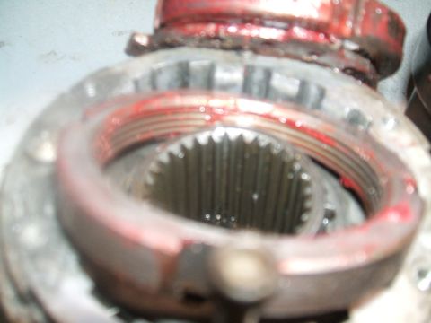 1995 Ford Bronco - A close-up view of a vehicle's differential gear assembly, showing internal components and grease.