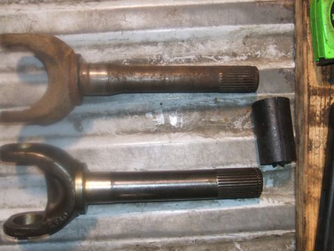 1995 Ford Bronco - Two driveshaft yokes are shown, one in a state of disrepair and the other appearing recently serviced.