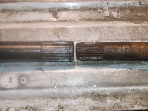 1995 Ford Bronco - Comparison of a worn splined shaft next to a new one, likely for a vehicle rebuild.