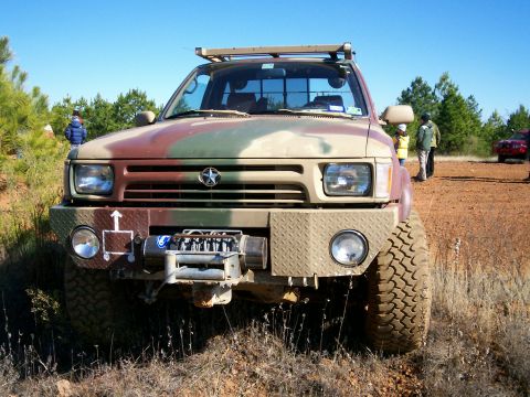 1993 Ford Bronco - This pickup truck features a camouflage paint scheme and an aftermarket bumper with a winch.