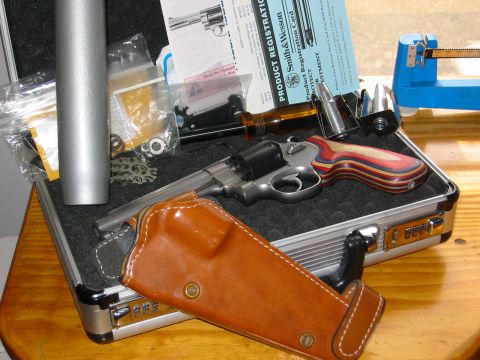 1996 Ford Bronco - A Smith & Wesson revolver, holster, and ammunition are laid out with product registration documents.