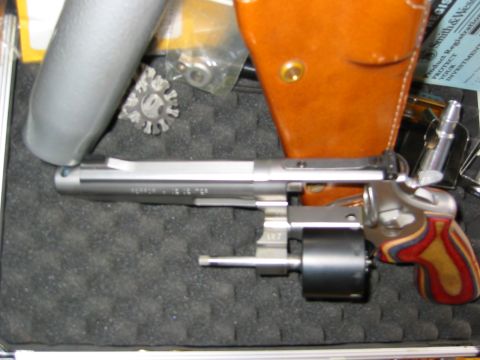 1996 Ford Bronco - A close-up view of a revolver handgun, its cylinder, and a leather holster.