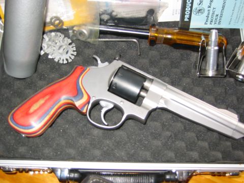 1996 Ford Bronco - A revolver with a distinctive multi-colored grip is shown with various tools and a single bullet.