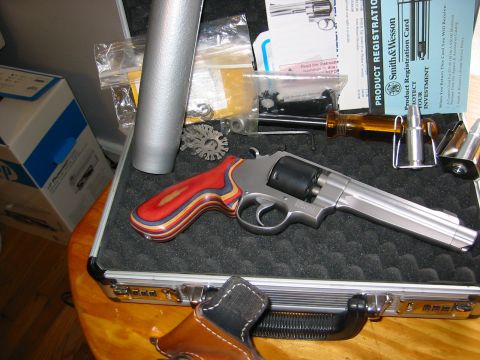 1996 Ford Bronco - Revolver and gun cleaning tools are laid out in a case with paperwork.