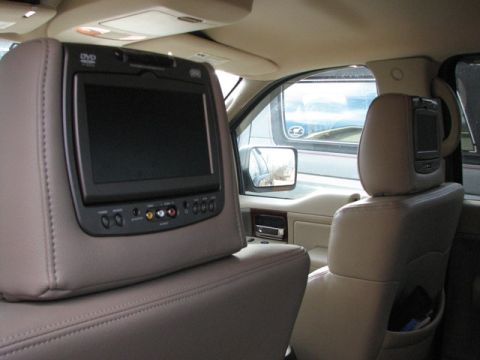 1991 Ford Bronco - The interior of a vehicle is shown, entertainment screens mounted on the headrests of the front seats.