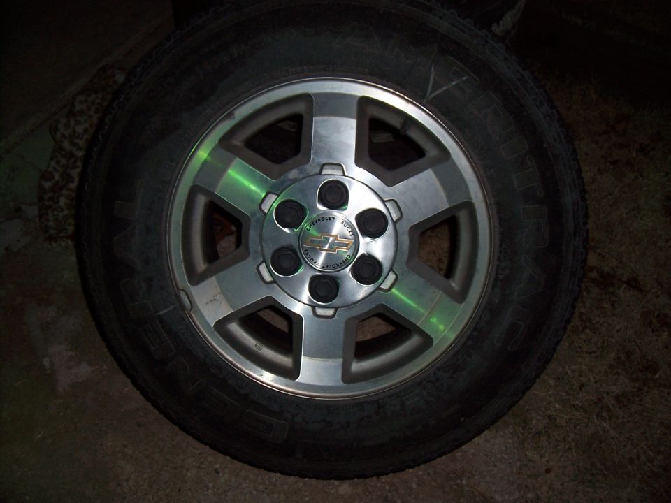 Close-up of a Chevrolet wheel with a tire. The center cap has the Chevrolet logo