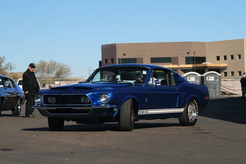 Blue 1968 Shelby GT500 Mustang with white stripes, parked next to another car