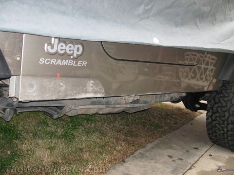1987 Suzuki Samurai - The side panel of a Jeep Scrambler shows the model name and a decorative decal.